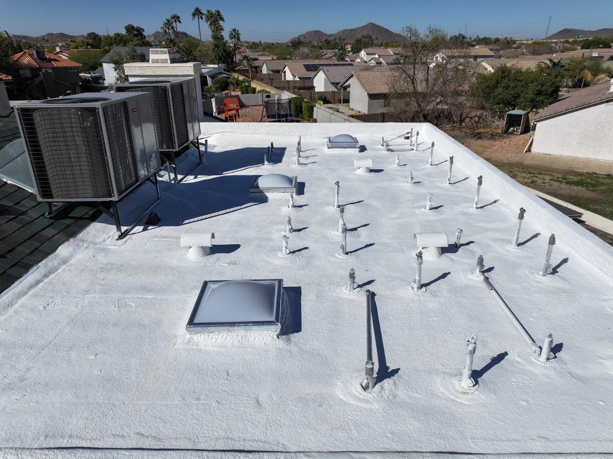 Reflective elastomeric coating on a flat commercial roof